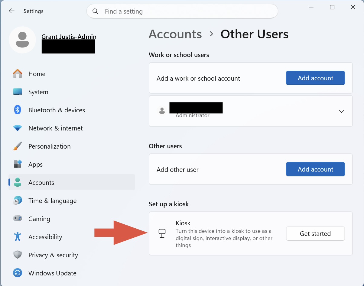 Windows 11 Settings window under “Accounts > Other Users.” It shows options to add a work or school account, add another user, or set up a kiosk. An arrow points to the “Kiosk” section with a “Get started” button, guiding the user to create a kiosk account.