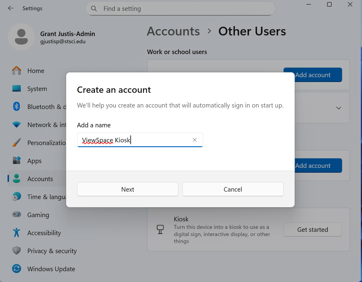 Windows 11 Settings window with a “Create an account” pop-up. The text field labeled “Add a name” is filled in with “ViewSpace Kiosk.” Buttons for “Next” and “Cancel” appear below the text field.